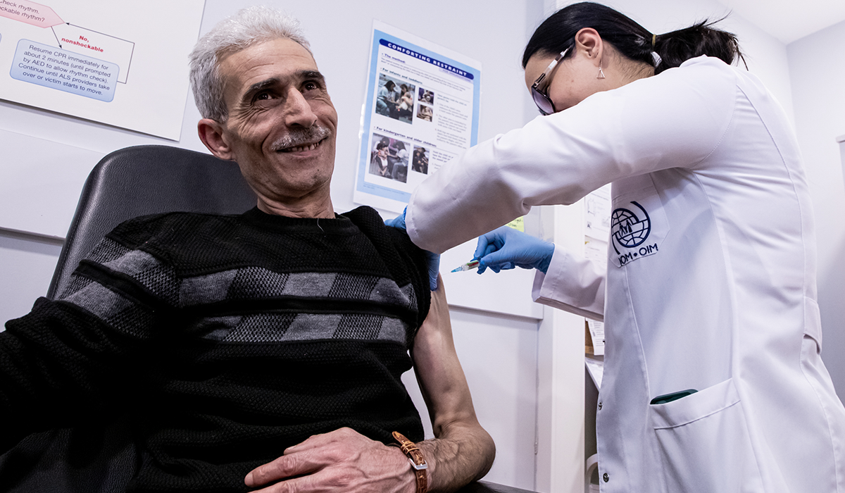 A Syrian man receives a medical check-up during the process of resettling to his new country. 