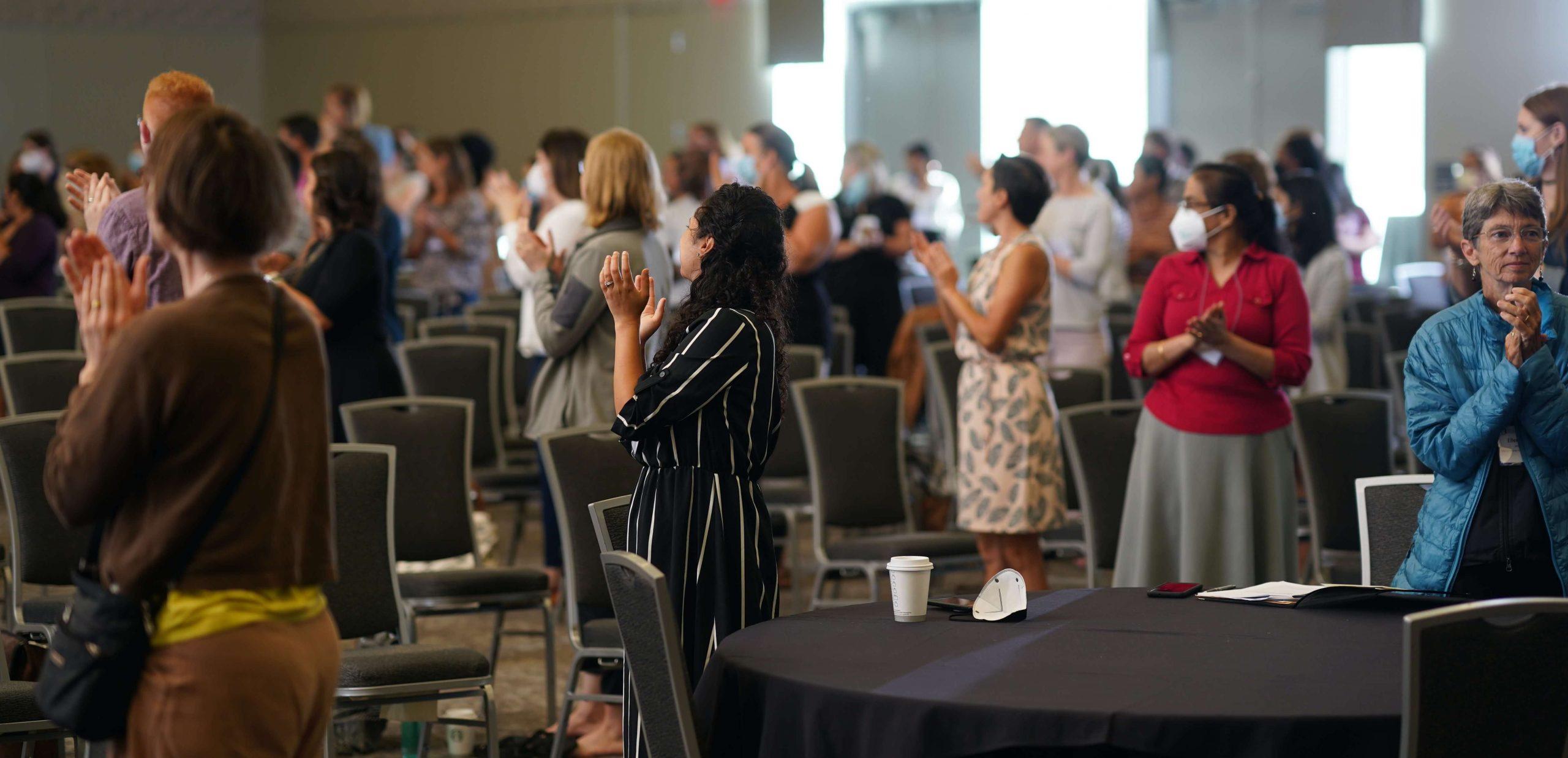 audience clapping at a conference