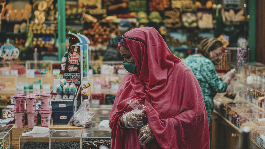 Woman in pink hijab grocery shopping