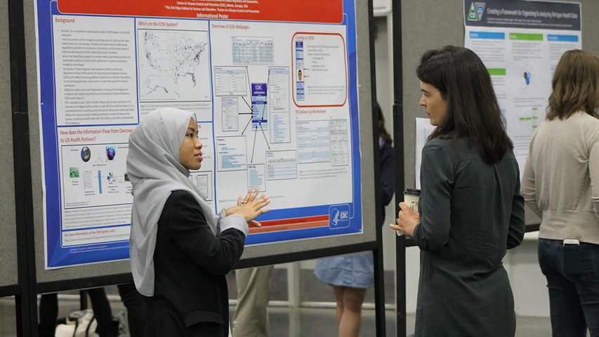 Two people discuss poster project at NARHC 2019